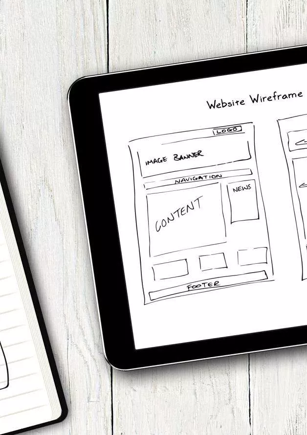 A website design wireframe on a tablet - Perfectly Optimized, website design company.
