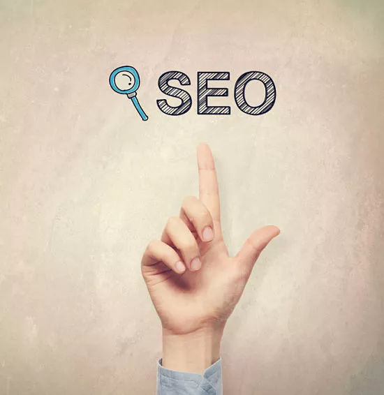 Perfectly Optimized - Perfectly Optimized can help you with YouTube SEO - hand pointing to SEO concept on a light brown wall background.